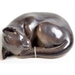 A Japanese porcelain model of a sleeping cat.  Condition Report: diagonal dimension 24cm, height