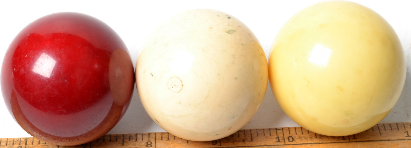 A set of two ivory billiard balls diameter 50.5mm, weight 258g. And a third ball.