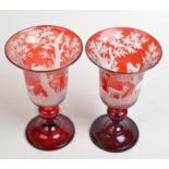 A pair of good bohemian, red flash glass goblets engraved with forest scenes and animals,