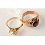 A 14ct. cultured pearl ring and a gold ring set a garnet.