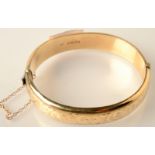 An engraved bangle, 15.6g. Condition Report: 9 carat.