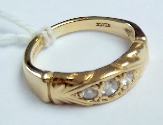 A 9ct gold ring set with three diamonds.