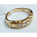 A 9ct gold ring set with three diamonds.