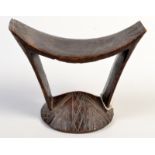 An African Somali carved dark wood headrest. Height 15.5cm, width 20.5cm.
