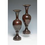 A pair of red serpentine slender vases with trumpet necks and octagonal bases. 31cm.