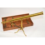 A 19th century brass 6cm telescope with table tripod and accessories in a fitted mahogany case.