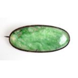 A large oval jade silver mounted brooch.