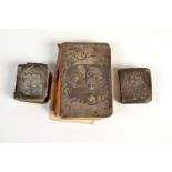 Three miniature leather bound books of common prayer with silver covers, the largest 12 x 8cm.