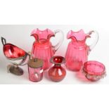 A pair of cranberry glass jugs, a W.M.F.