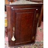 A George III oak pane corner cupboard.