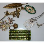 A ring with concealed watch, a green paste stone set cuff, and other costume
jewellery. Condition