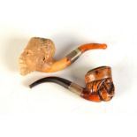 A meerschaum Negro carved pipe and one other meerschaum carved pipe. Condition Report: Signs of use,