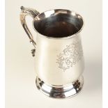 A Georgian silver bellied mug with acanthus capped handle, elaborately engraved with initials,