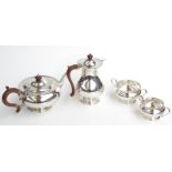 A silver four piece tea service of circular form with beaded rims, by William Neale, Birmingham,