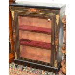 A Victorian ebonised ormolu mounted side cabinet with single glazed door and ormolu mounts,