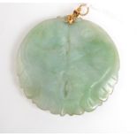 A jade pendent carved and pierced with two confronting fish.