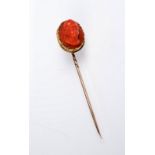 A coral cameo gold stick pin.