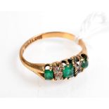 A late Victorian Glasgow hallmarked 18ct. gold ring set three emeralds and four diamonds.