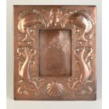 A Newlyn copper easel photograph frame with shaped strut, with four fish in two confronting pairs