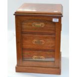 A fine walnut veneered crossbanded cigar cabinet with a glass door opening onto three drawers,