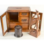 A smokers' oak cabinet, an Austrian ceramic tobacco jar and an Eastern carved wood bird.