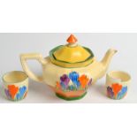 A Clarice Cliff crocus pattern teapot, spout chipped and a pair of matching egg cups. Condition