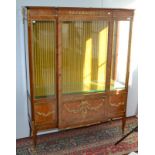 A good French vitrine in transitional style with chased ormolu mounts and of breakfront form,