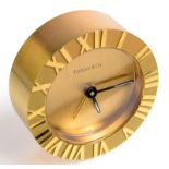A Tiffany's desk clock, the outer brass rim cast with Roman Numerals, diameter 6.2cm.