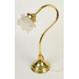 A brass electric table lamp with glass flower shade.