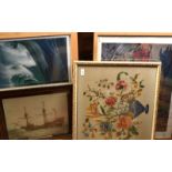 A framed floral needlework and three other pictures.