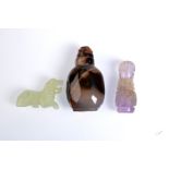 An agate snuff bottle, an amethyst carved snuff bottle and a carved stone lion.