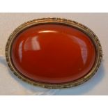 A 9ct. gold brooch set with a carnelian cabochon, length 2.