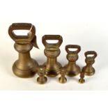 Seven bell shaped brass weights, seven pounds to two ounces.