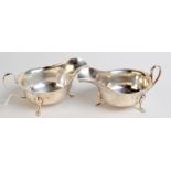 A pair of silver sauce boats with shaped rims, each on three cabriole legs, 7oz.