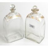 Two Dutch rectangular section decanters each with gilt decorated shoulder.