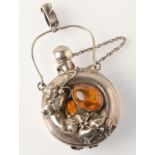 An Art Nouveau style silver perfume bottle set with amber amongst naturalistic foliage.  Condition
