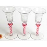 A set of three 18th century glasses, each bell shaped bowl engraved with vines and stars,