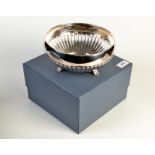 A Canadian demi-fluted circular silver bowl resting on three feet, stamped 'Birks Sterling', 382gms,