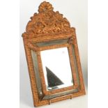 A mirror in Dutch style. Condition Report: It is made of pressed brass.