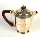 A Goldsmiths & Silversmiths silver hot water jug of cylindrical form, London, 1944, 12oz.