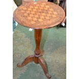 A Victorian walnut parquetry and marquetry veneered tripod games table.