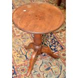 A mahogany tripod table.