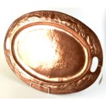 A rare large Newlyn copper oval twin handled tray the rim decorated with fish, seaweed and shells,