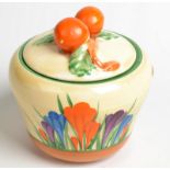 A Clarice Cliff crocus pattern conserve pot, the lid moulded with oranges.