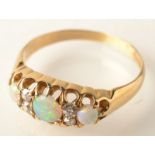 An 18ct. gold diamond and opal, claw set ring.