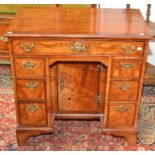 A Georgian style mahogany kneehole desk with brass carrying handles, width 80.5cm.