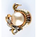 A good mabe pearl gold mounted, diamond set, 1950s brooch, in the form of a swan.