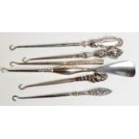 A silver mounted shoe horn/button hook, together with five silver handled button hooks. Condition