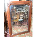 A mahogany framed mirror, with shaped upper corners, 134 x 89cm.