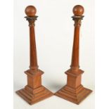 A pair of light oak, ball finial, classical column obelisks, height 43.5cm.